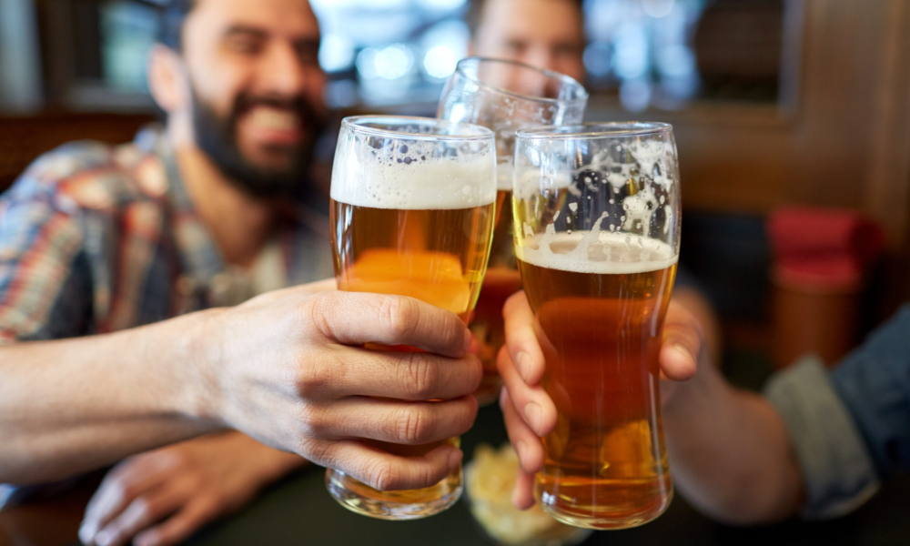 happy male friends drinking beer at bar or pub