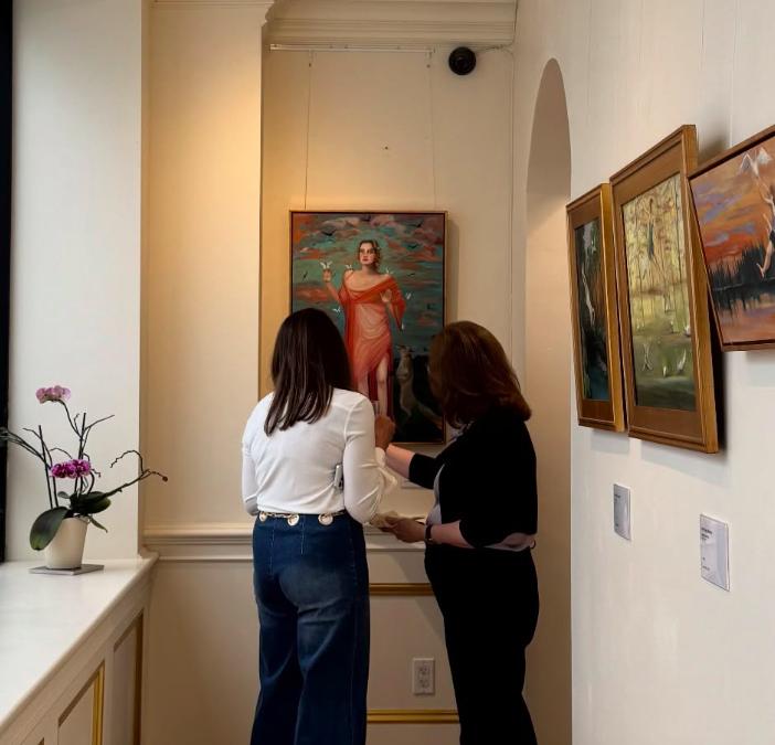 people looking at paintings at art museum